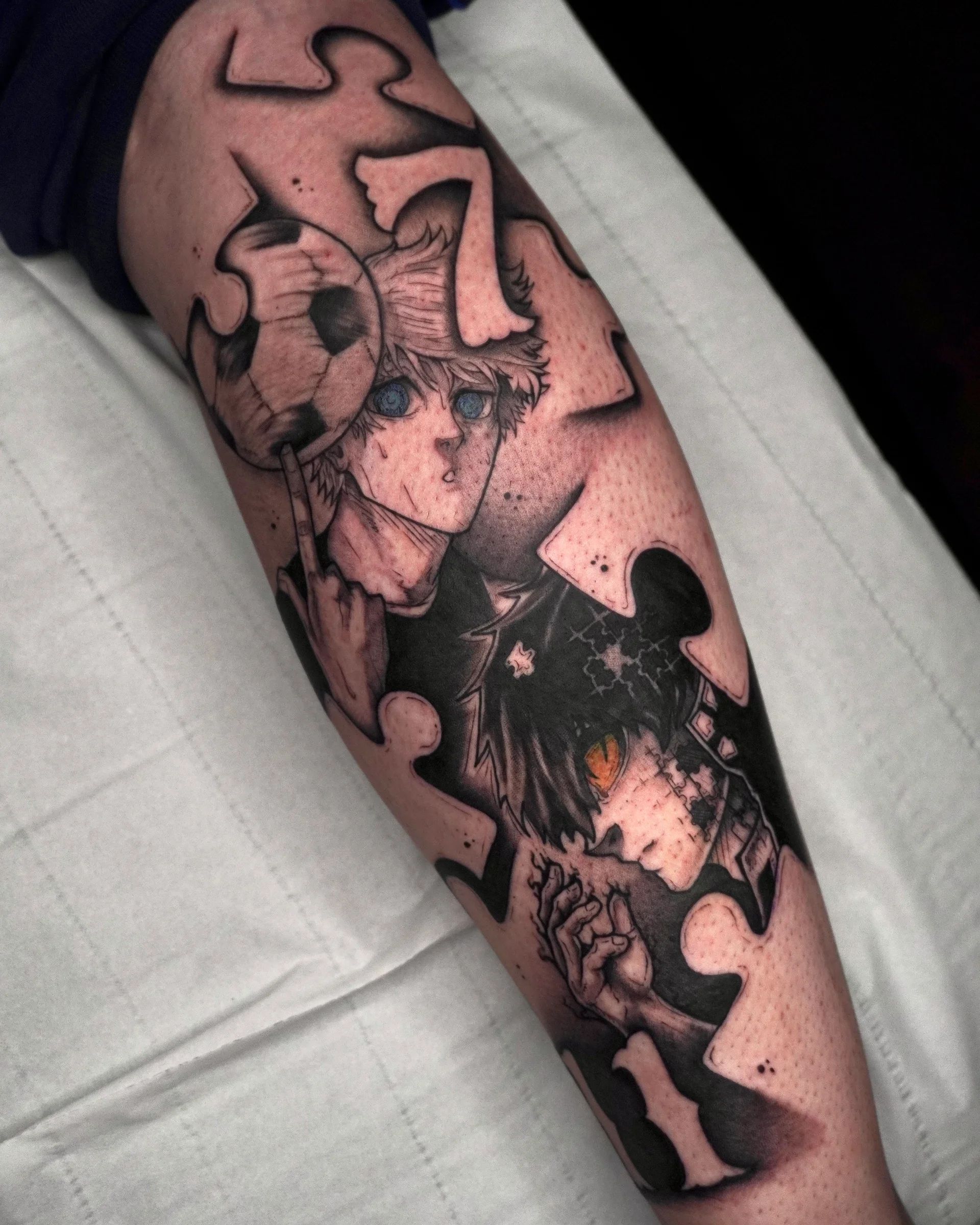 Anime characters among puzzle pieces, with a football, on the forearm