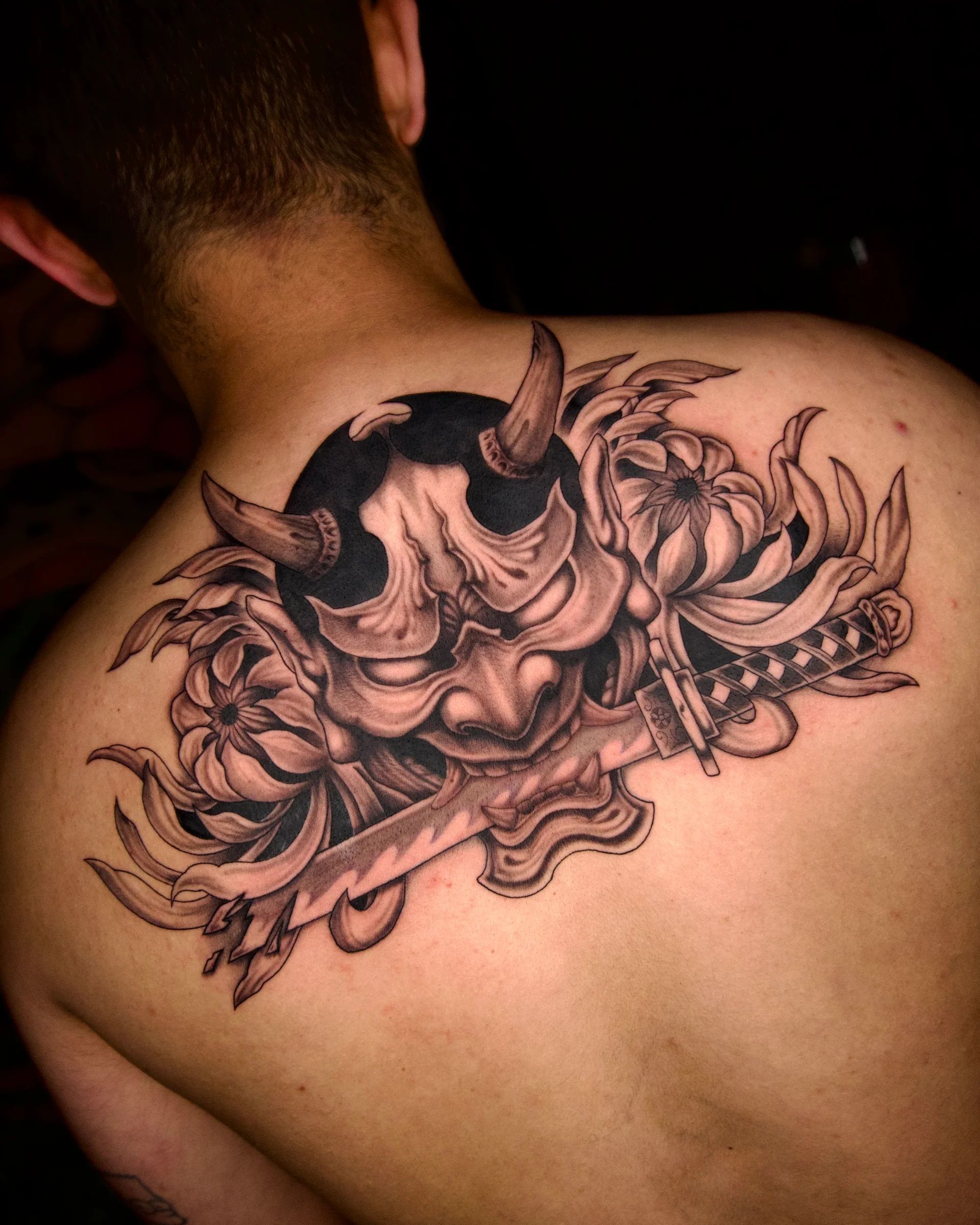 Hannya mask with a katana and chrysanthemums on the back