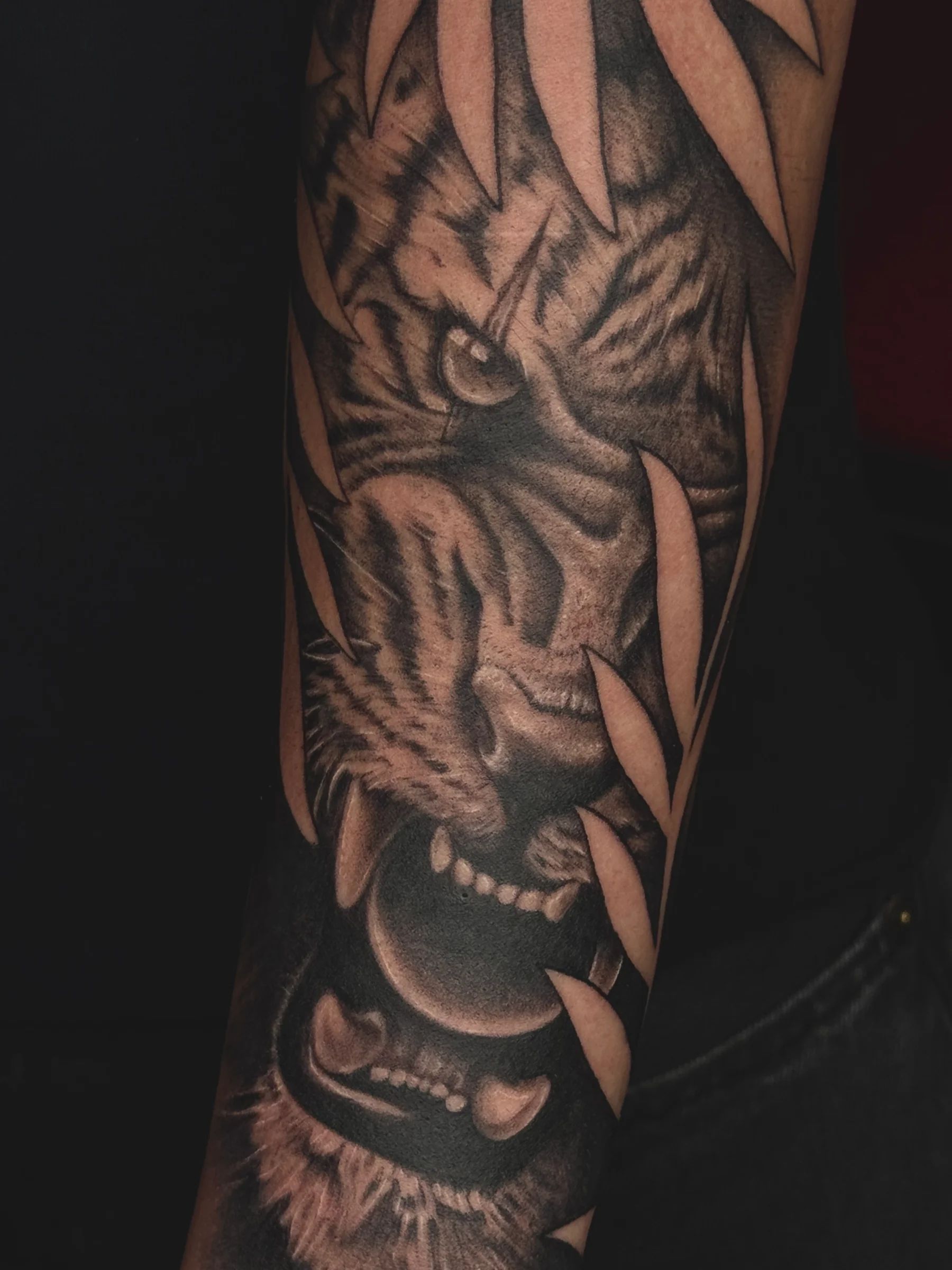 Tigre entre hojas de bambú en el antebrazo