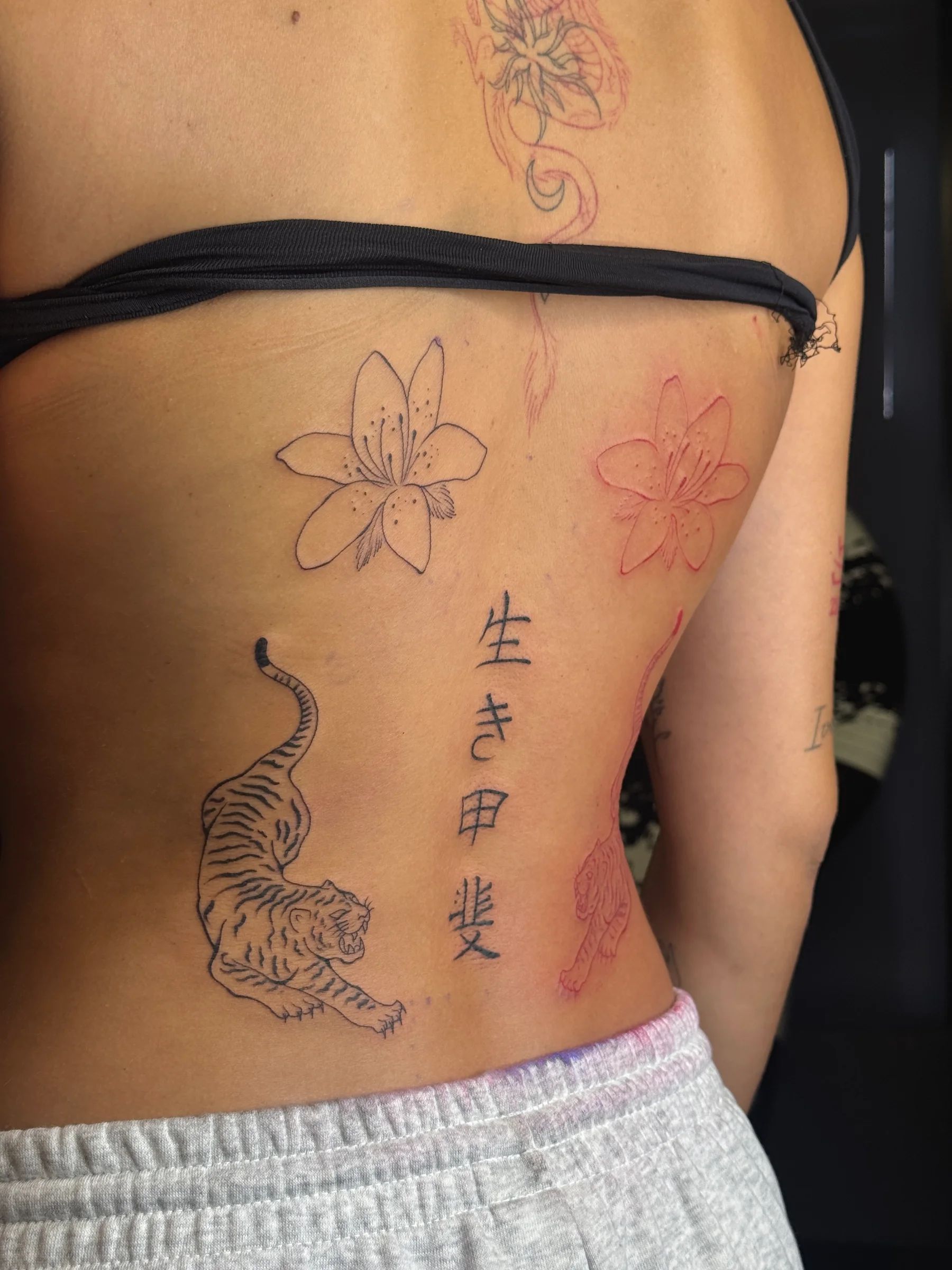 Lily, tiger, red flowers and Japanese characters on the back
