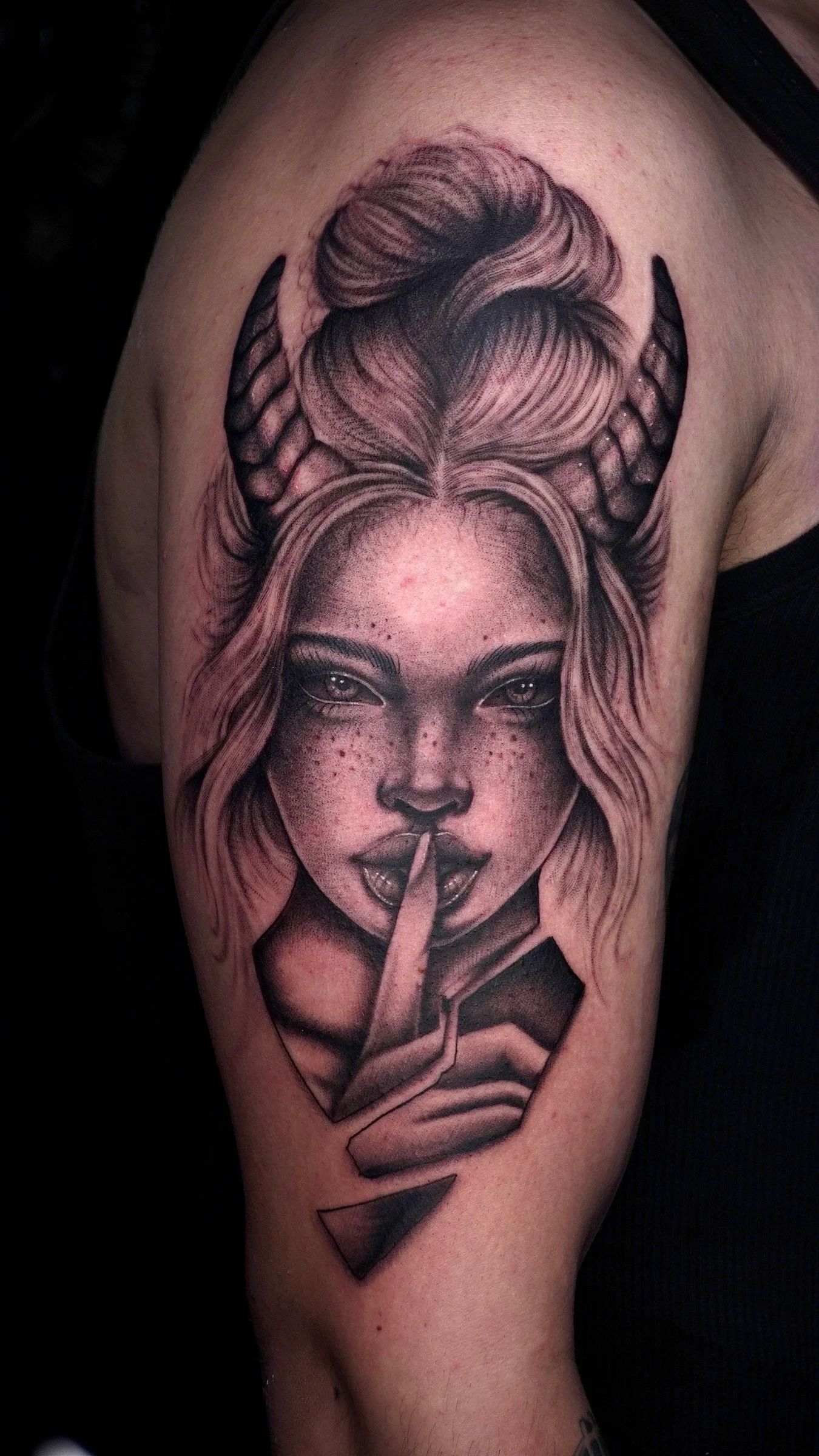 Woman with horns asking for silence, on the arm